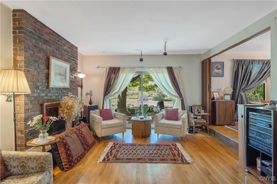 The beautiful brick wood-burning fireplace is a focal point of the room, as it is also visible from the formal dining room.  There are sliding doors leading out to the back yard.