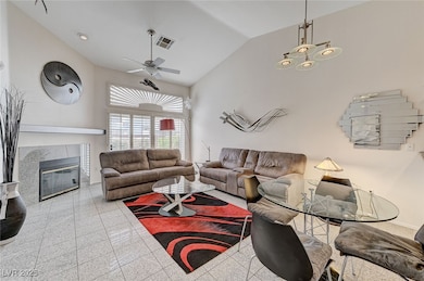 Living room featuring lofted ceiling, ceiling fan,