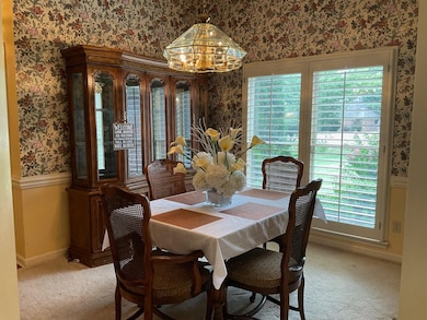 Dining area featuring light carpet