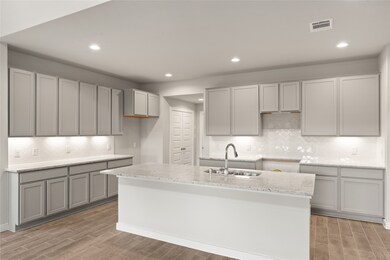 This kitchen is by far any chef’s dream! This spacious kitchen features high ceilings, cool stained wood cabinets, granite countertops, SS appliances, modern tile backsplash, recessed lighting, extended counter space, granite kitchen island with double sink and space for breakfast bar, and a walk-in pantry all overlooking your huge family room.
