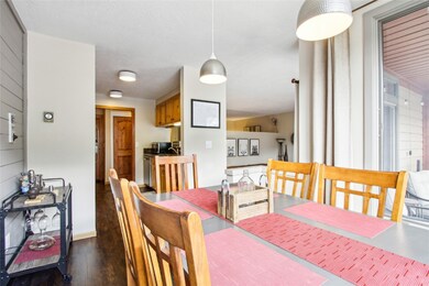 Dining area featuring dark wood-style flooring