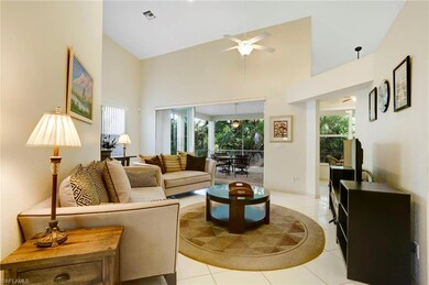 Living area featuring high vaulted ceiling, tile f