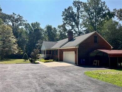 Ranch-style house with a garage and a front lawn