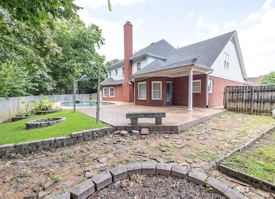 Rear view of property featuring an outdoor fire pit, a fenced backyard, a patio, and a shingled roof