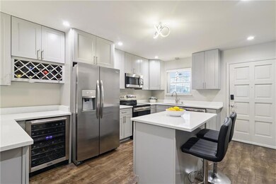 Added bar area complete with beverage fridge, built in wine rack and raised counter for additional seating sets this home apart from any others in the building