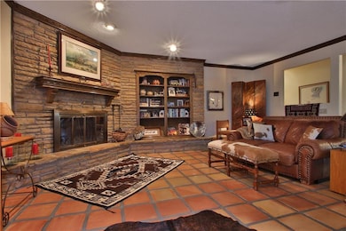 Living room with stone fireplace and built-in book