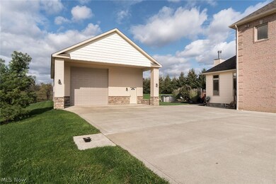 Outbuilding 32x60 ft. Water, gas, and electric.  Rough in for bathroom.  Exterior lighting on timers.  13'6