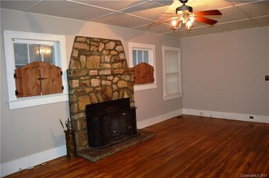 Living Room with Wood Stove & Hardwood Floors