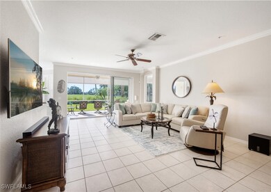 Living room with ceiling fan, light tile patterned