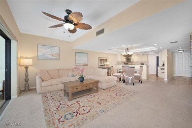 Living room with a ceiling fan, a tray ceiling, li