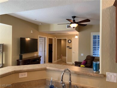 From kitchen looking to open living, doors from le