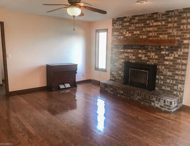 Family room with wood flooring and a fireplace.