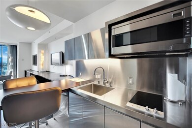 Kitchen with black electric stovetop, stainless st