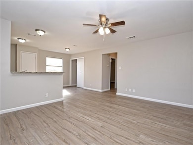 Spare room with a ceiling fan and light wood-style flooring