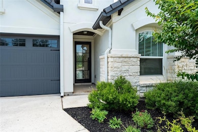 Entrance to property featuring stucco siding, a g