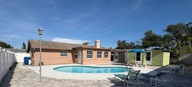 Back Exterior with pool and new pavers and storage