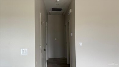Hallway with dark hardwood / wood-style flooring