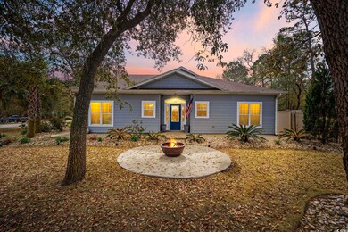 Ranch-style house featuring an outdoor fire pit an