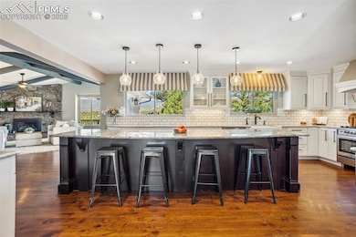 Gourmet Kitchen Island featuring tasteful marble backsplash