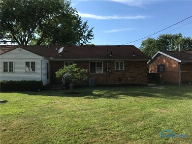 Back of home boasts additional sunroom and deck ar