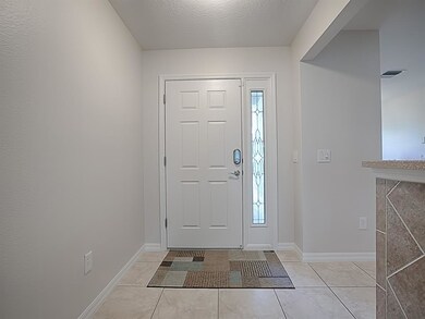 ENTER INTO A SPACIOUS TILED FOYER.