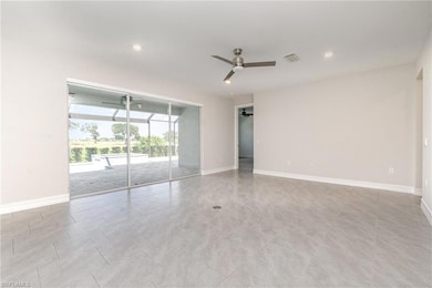 Empty room with a sunroom, ceiling fan, recessed lighting, and light tile patterned flooring