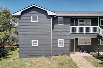 View of front of property featuring a patio, roof