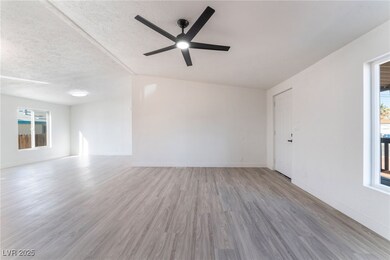Unfurnished room with baseboards, ceiling fan, vau