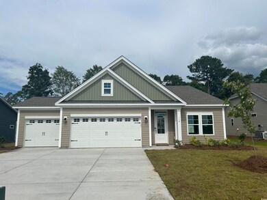 Craftsman inspired home featuring concrete driveway, board and batten siding, a garage, a front yard, and roof with shingles