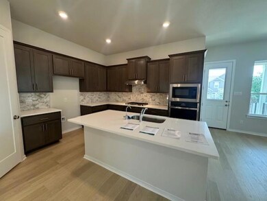Kitchen featuring appliances with stainless steel