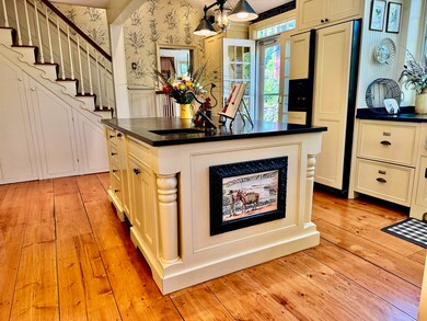 Reverse picture of island with dishwasher in the background.