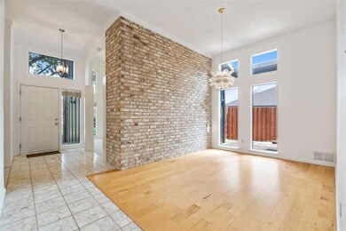 The dining room features hard wood floors and wind