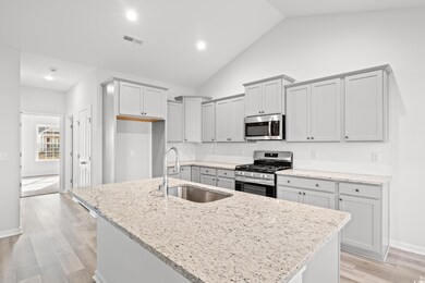 Kitchen with high vaulted ceiling, a center island