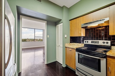 Kitchen shown opening to the living areas.