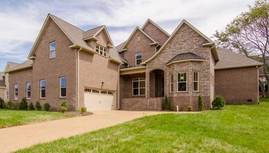 Courtyard driveway, 4 car garage, plenty of space for everyone. 