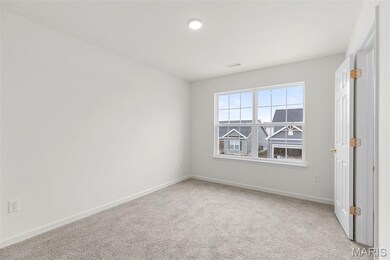 Spare room featuring light carpet and baseboards