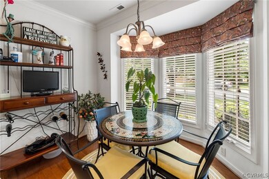 Dining space , crown molding, and bay window