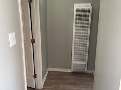 Corridor featuring dark wood-type flooring