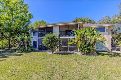 Back of property featuring a yard and a sunroom