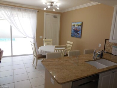 Dining area featuring crown molding, a chandelier, and light tile patterned floors