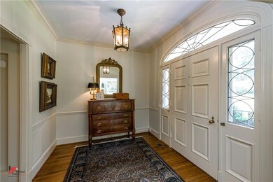 Inviting entry with beautiful hardwood floors, lea