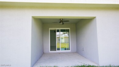 Doorway to property with stucco siding, a ceiling