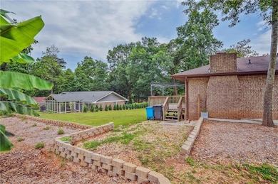 View of grassy yard with a wooden deck