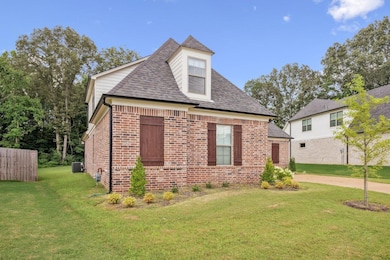 View of side of property featuring brick siding and roof with shingles