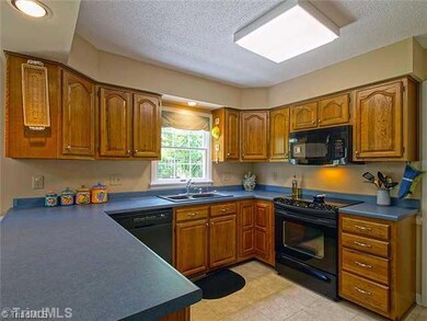 Kitchen. Generous cabinet and counterspace in the kitchen, in addition is a food pantry.  The laundry room is conveniently located to the kitchen and has a built in desk, utility sink and overhead cabinet storage.