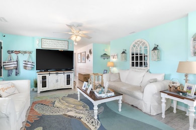 Living area featuring wood finished floors and ceiling fan