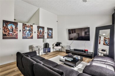 Living area with wood finished floors and a textured ceiling