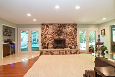 Family room with dramatic stone fireplace , bevera