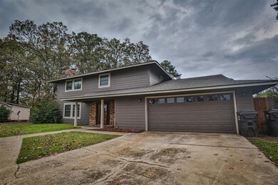 Front of property with a garage and a front yard