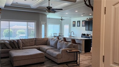 Living room featuring coffered ceiling, dark hardw